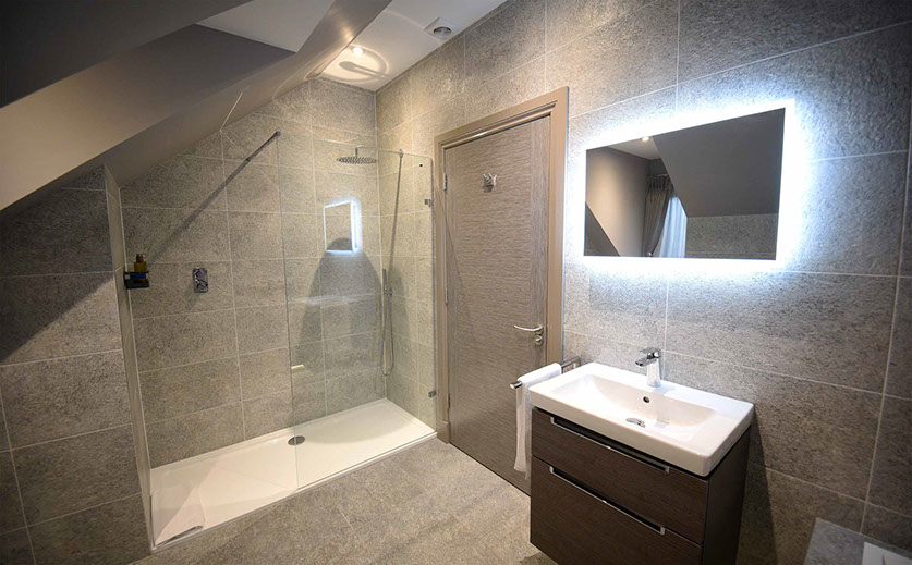 Taransay House Luxury Bed and Breakfast in Portree contains a spacious modern bathroom with bath shower and electric mirror icon