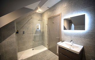 Taransay House guest rooms contain spacious luxury bathrooms with powerful shower bath and electric mirror